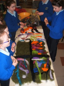 Helping the younger pupils lay out a wall hanging